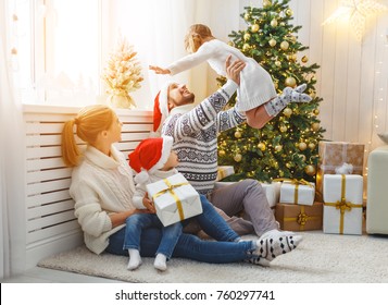 Happy Family Mother Father And Children At Home On Christmas Morning
