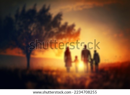 Happy family: mother, father, children son and daughter on nature on sunset blurred background