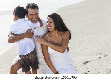 A Happy Family Of Mother, Father Parents & Boy Son Child, Playng And Having Fun In The Waves Of A Sunny Beach