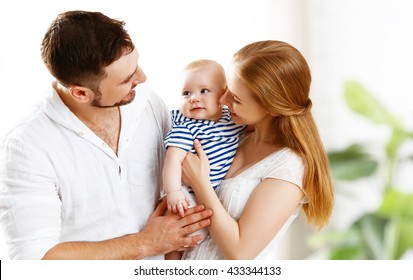 Happy Family Mother, Father And Son, Child Baby At Home