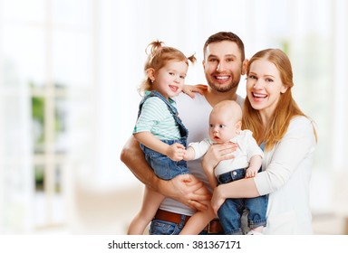 happy family mother, father and two children at home