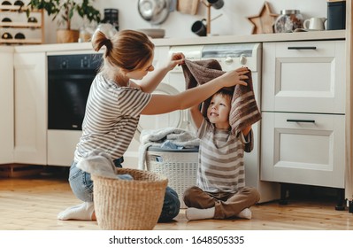 Happy family mother housewife and child son in laundry with washing machine 
 - Powered by Shutterstock