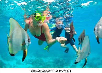 Happy family - mother, kids in snorkeling mask dive underwater, explore tropical fishes in coral reef sea pool. Travel active lifestyle, beach adventure, swimming activity on summer holiday with child - Powered by Shutterstock