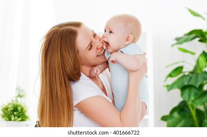 Happy Family Mother Playing  With Newborn Baby