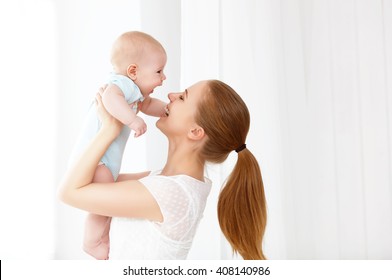 Happy Family Mother Playing  With Newborn Baby