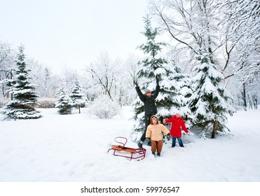 Happy Family (mother With Small Boy And Girl) In Winter City Park