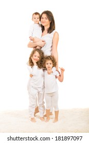 Happy Family Of Mother With Three Kids And The Girls Giving Thumbs Up Against White