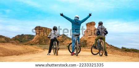 Happy family with mountain bike ( Monegros desert,  Huesca province in Spain)