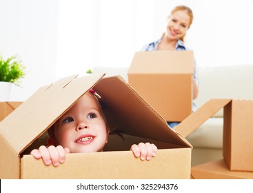 happy family moves into a new apartment. happy baby in a cardboard box