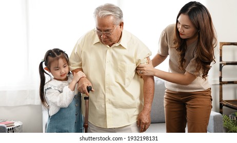 Happy Family Multi-generation Mother and daughter taking care of the senior grandfather help walking together in the house happiness, Elderly retirement concept.