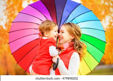  Happy Family Mum And Child Daughter With Rainbow Colored Umbrella Under Rain On Nature