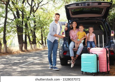 Happy Family Near Car Trunk On Sunny Day. Road Trip