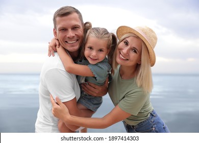 Happy family near sea on sunny summer day