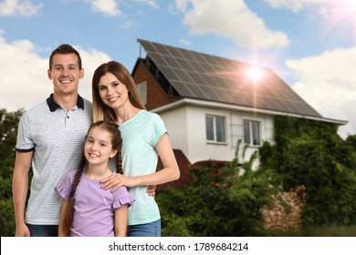 Happy Family Near Their House With Solar Panels. Alternative Energy Source