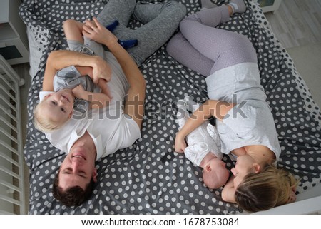 Similar – Image, Stock Photo Relaxed mother and sons playing over the bed