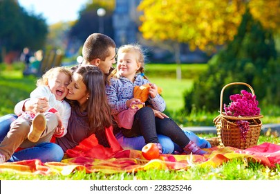 Happy Family On Autumn Picnic In Park