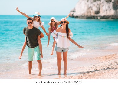 Happy Family On The Beach During European Vacation