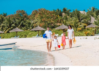 Happy Family On The Beach During Summer Vacation