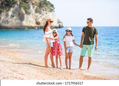 Happy Family On The Beach During Summer Vacation