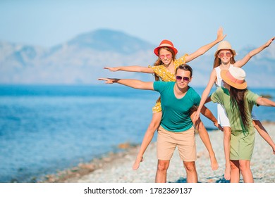 Happy family on a beach during summer vacation - Shutterstock ID 1782369137