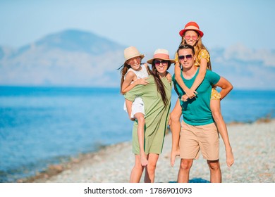 Happy family on a beach during summer vacation - Shutterstock ID 1786901093