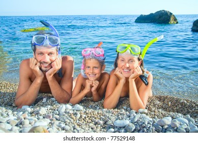 Happy Family On Beach With Snorkles Ready To Have A Good Time Swimming