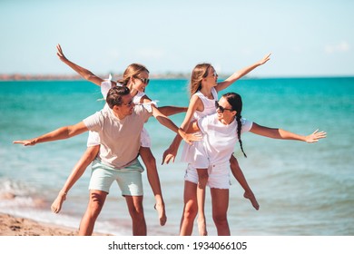 Happy Family On The Beach At Summer Vacation