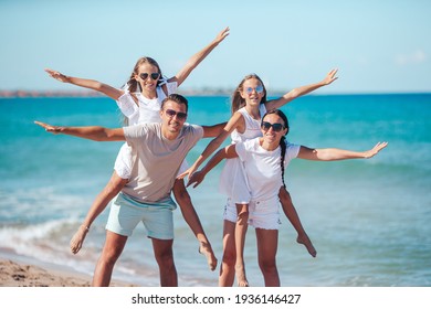 Happy Family On The Beach At Summer Vacation