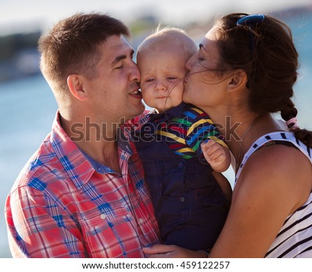 Happy family on the beach in summer day