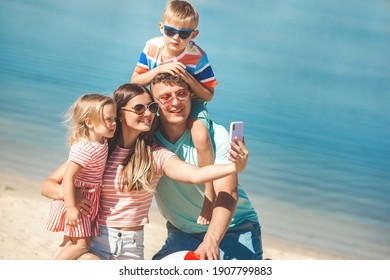 Happy Family On The Beach. Family Vacation. People Making Selfie On Cell Phone