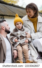 Happy Family On A Beautiful Fall Picnic In The Park. Cozy Autumn Vibes. Young Father, Mother And Their Cute Son Spending Quality Time Together, Having Fun