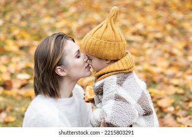 Happy Family On A Beautiful Fall Picnic In The Park. Cozy Autumn Vibes. Young Mother And Her Cute Son Spending Quality Time Together, Having Fun In The Park 