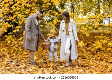 Happy Family On A Beautiful Fall Picnic In The Park. Cozy Autumn Vibes. Young Father, Mother And Their Cute Sn Spending Quality Time Together, Having Fun.