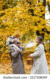 Happy Family On A Beautiful Fall Picnic In The Park. Cozy Autumn Vibes. Young Father, Mother And Their Cute Sn Spending Quality Time Together, Having Fun.