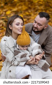 Happy Family On A Beautiful Fall Picnic In The Park. Cozy Autumn Vibes. Young Father, Mother And Their Cute Sn Spending Quality Time Together, Having Fun.