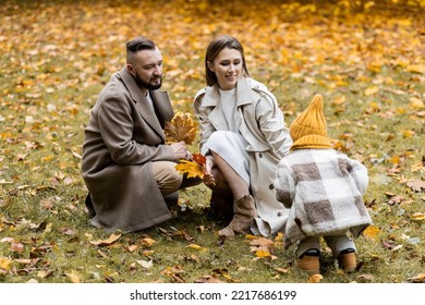 Happy Family On A Beautiful Fall Picnic In The Park. Cozy Autumn Vibes. Young Father, Mother And Their Cute Sn Spending Quality Time Together, Having Fun. 