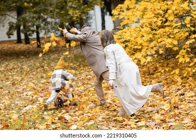 Happy Family On A Beautiful Fall Picnic In The Park. Cozy Autumn Vibes. Young Father, Mother And Their Cute Sn Spending Quality Time Together, Having Fun.