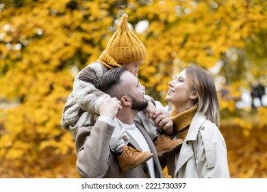 Happy Family On A Beautiful Fall Picnic In The Park. Cozy Autumn Vibes. Young Father, Mother And Their Cute Sn Spending Quality Time Together, Having Fun.