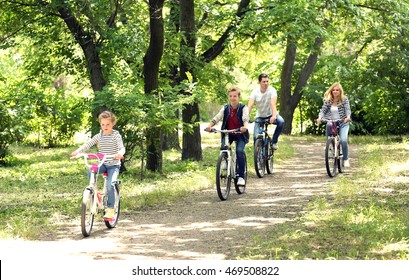 Happy Family On Bike Ride In Park