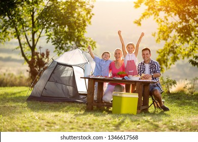 Happy Family On Camping At Sunset