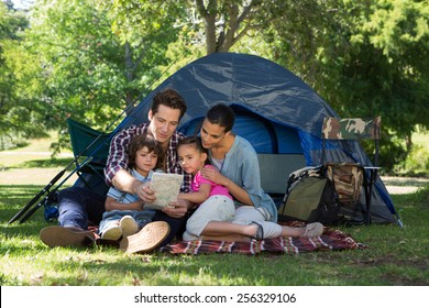 Happy Family On A Camping Trip In Their Tent On A Sunny Day