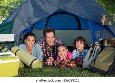 Happy Family On A Camping Trip In Their Tent On A Sunny Day