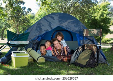 Happy Family On A Camping Trip In Their Tent On A Sunny Day