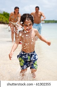 Happy Family On Holidays Playing In The Sea