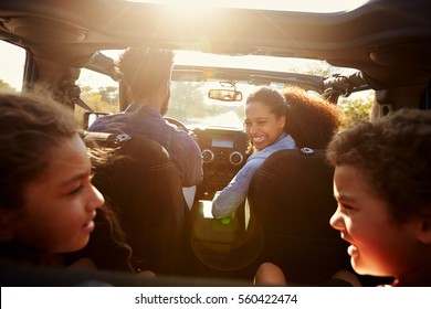 Happy family on a road trip in their car, rear passenger POV - Shutterstock ID 560422474