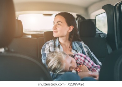 Happy Family On A Road Trip In Their Car. Dad, Mom And Daughter Are Traveling By The Sea Or The Ocean Or The River. Summer Ride By Automobile