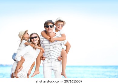 Happy Family On Sea Beach At Resort