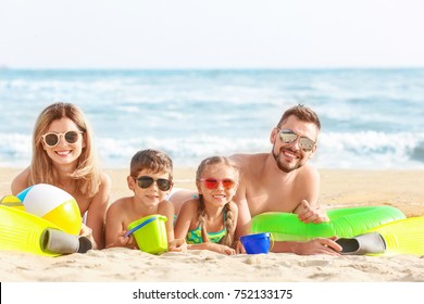 Happy Family On Sea Beach At Resort