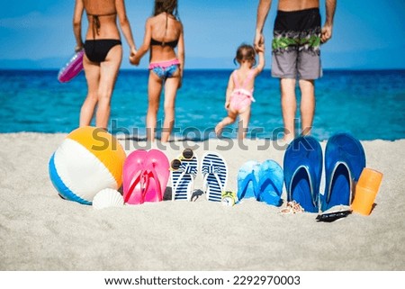happy family on the sea with slippers on nature background