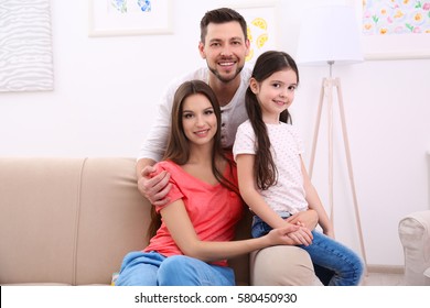 Happy Family On Sofa At Home